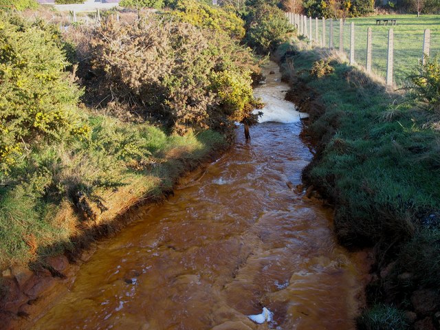 Polluted stream flowing through the Lon Goch Recreation Ground